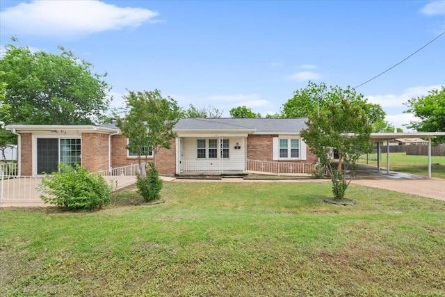 ranch-style house featuring a front lawn, fence, brick siding, driveway, and a carport