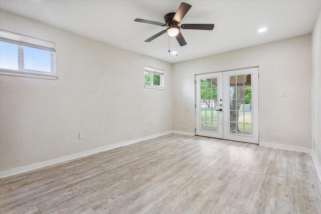 spare room featuring french doors, baseboards, and wood finished floors