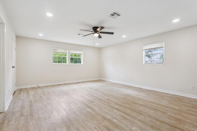 spare room featuring a ceiling fan, visible vents, baseboards, recessed lighting, and light wood-style flooring