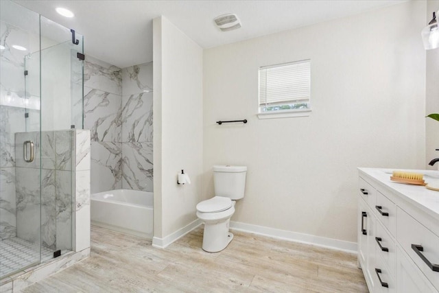 full bathroom with a garden tub, wood finished floors, vanity, toilet, and a marble finish shower
