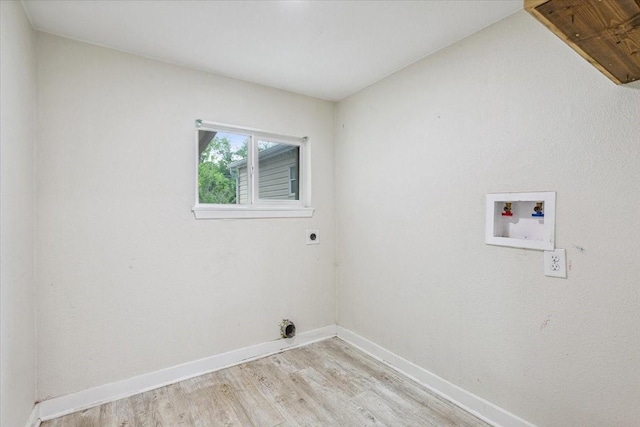 clothes washing area featuring washer hookup, laundry area, electric dryer hookup, baseboards, and light wood-style floors