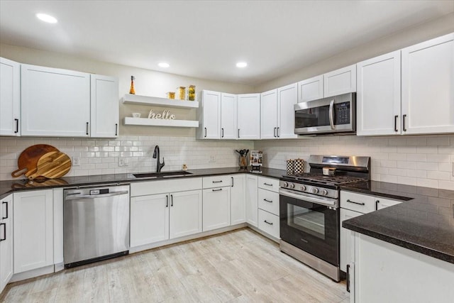 kitchen featuring a sink, appliances with stainless steel finishes, and tasteful backsplash