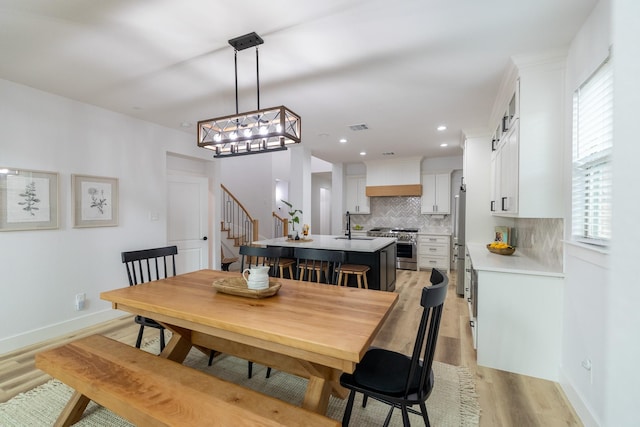 12472 Jack Pine Ct, Frisco, TX 75035 - dining room featuring light wood-type flooring, stairway, a chandelier, baseboards, and recessed lighting