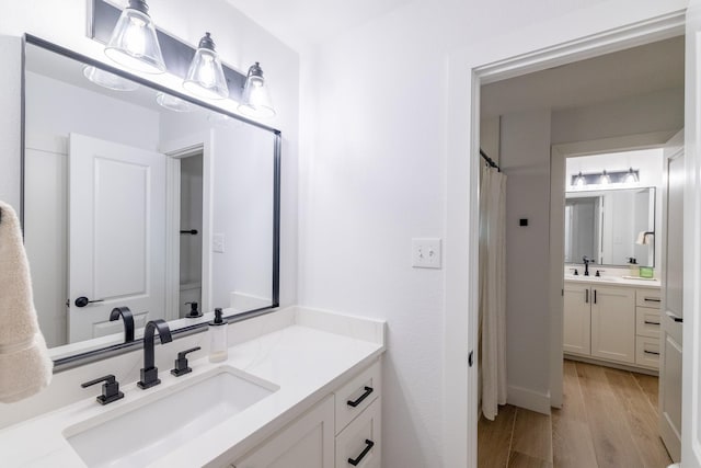 12472 Jack Pine Ct, Frisco, TX 75035 - full bathroom featuring wood finished floors and two vanities