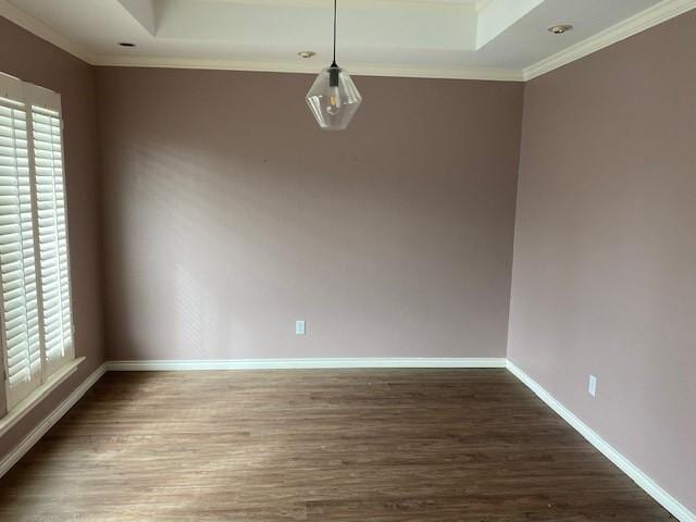 empty room with plenty of natural light, baseboards, and wood finished floors