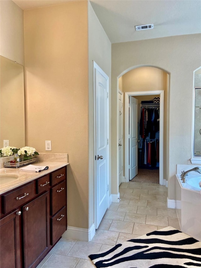 3724 Estates Way, Mckinney, TX 75072 - bathroom with visible vents, a garden tub, vanity, baseboards, and a spacious closet
