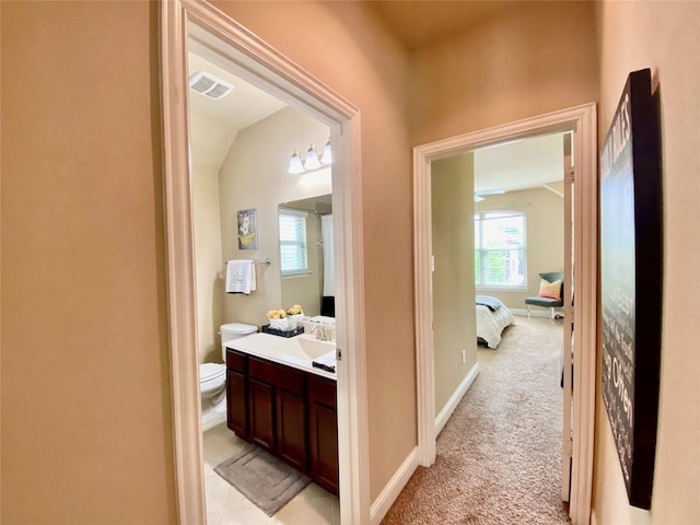 3724 Estates Way, Mckinney, TX 75072 - corridor with visible vents, lofted ceiling, baseboards, light colored carpet, and a sink
