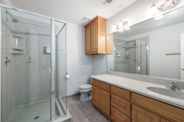 231 Granada Calle St, Granbury, TX 76049 - bathroom with a shower stall, tile patterned flooring, vanity, and toilet