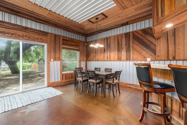 231 Granada Calle St, Granbury, TX 76049 - dining space featuring concrete floors and wooden walls