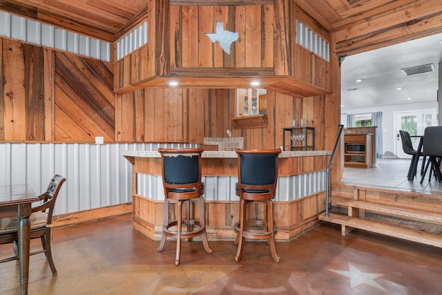 231 Granada Calle St, Granbury, TX 76049 - kitchen with concrete floors and wood walls