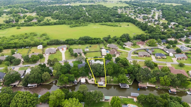 231 Granada Calle St, Granbury, TX 76049 - aerial perspective of suburban area featuring property parcel outlined, a large body of water, and a tree filled landscape