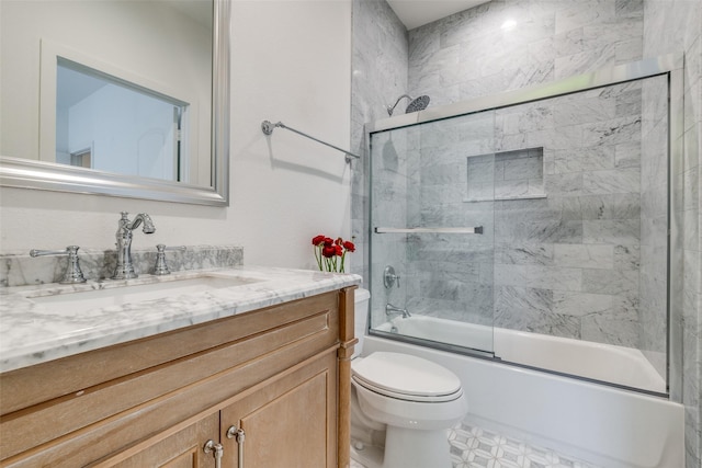 full bath with vanity, combined bath / shower with glass door, and toilet