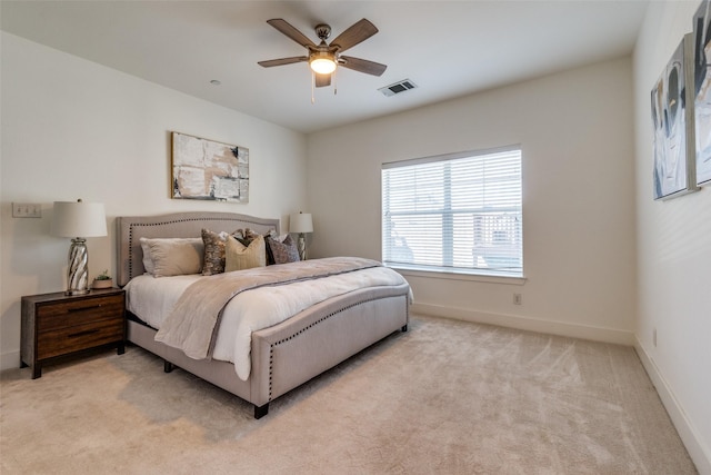 bedroom with a ceiling fan, baseboards, light colored carpet, and visible vents