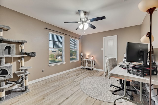 office space with baseboards, ceiling fan, and wood finished floors