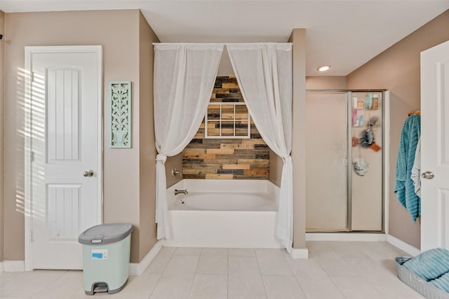bathroom featuring tile patterned floors, a shower stall, baseboards, and a bath
