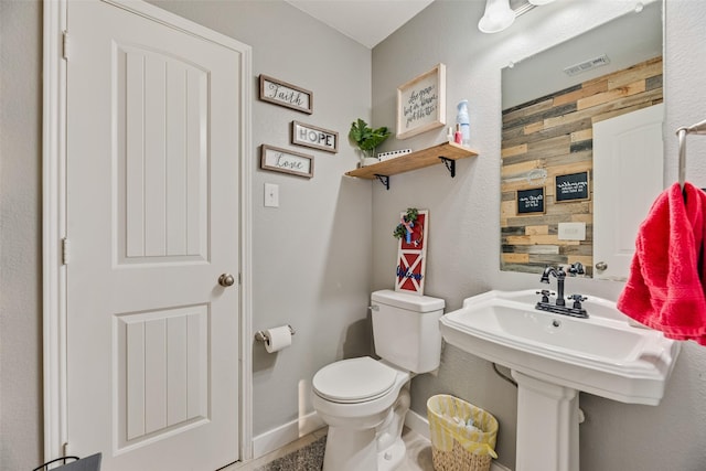bathroom with visible vents, baseboards, and toilet