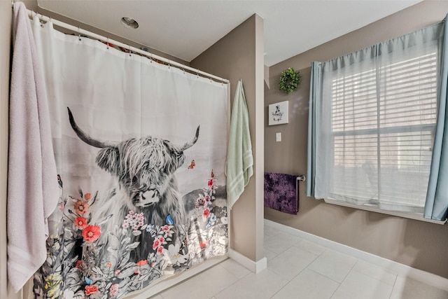 full bathroom featuring baseboards, tile patterned floors, and curtained shower