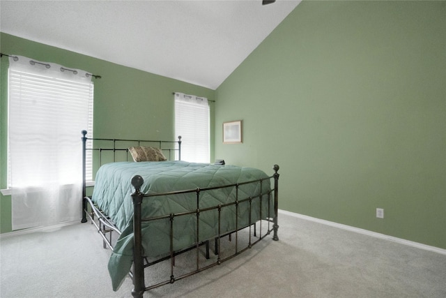 bedroom with baseboards, carpet flooring, and high vaulted ceiling