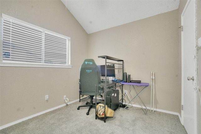 carpeted office space featuring baseboards and lofted ceiling