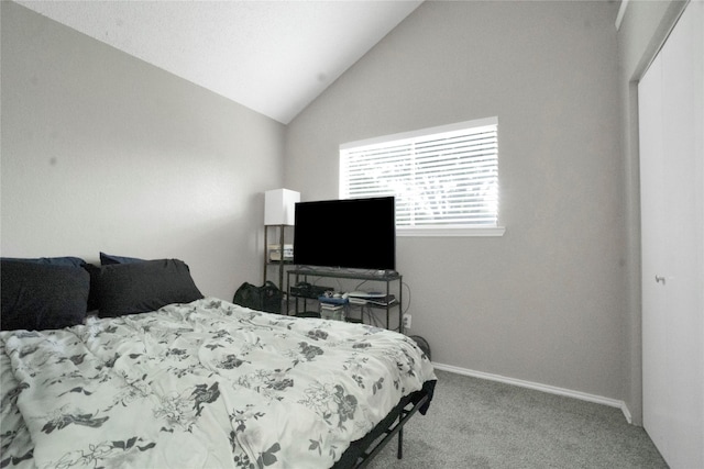 carpeted bedroom with baseboards and vaulted ceiling