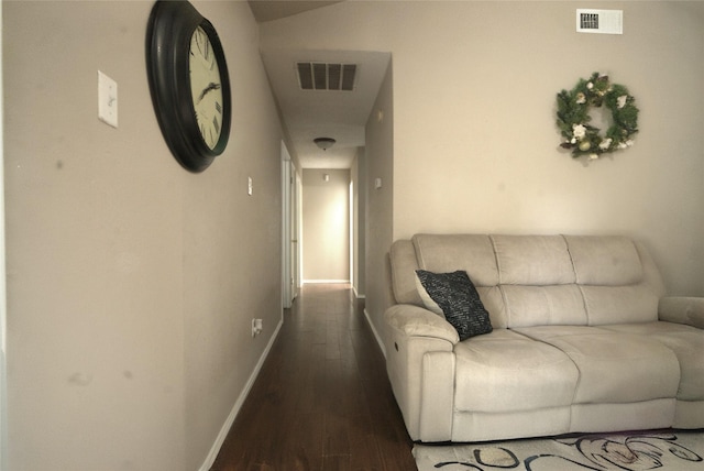hall featuring visible vents, dark wood-style flooring, and baseboards