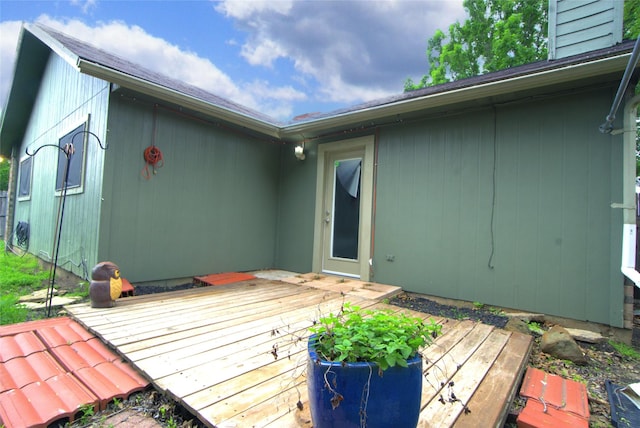 rear view of property featuring a deck