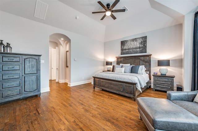 bedroom featuring ceiling fan, visible vents, arched walkways, baseboards, and dark wood-style floors