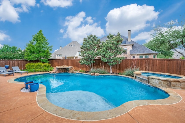 view of swimming pool featuring a fenced backyard, a patio, and a pool with connected hot tub