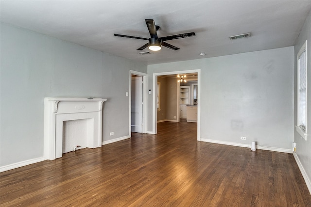 unfurnished living room featuring baseboards, ceiling fan, visible vents, and wood finished floors