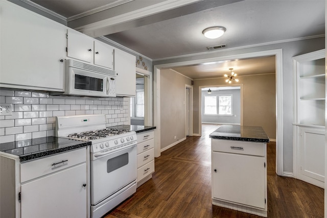 kitchen with visible vents, ornamental molding, decorative backsplash, and white appliances