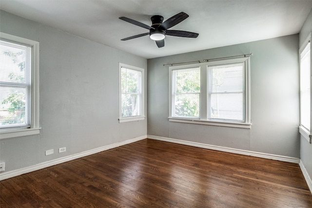 unfurnished room with baseboards, ceiling fan, wood finished floors, and a healthy amount of sunlight