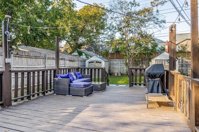 deck with an outbuilding, a shed, a fenced backyard, and an outdoor hangout area