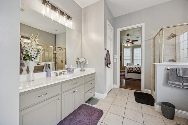 bathroom featuring ceiling fan, tile patterned flooring, a shower stall, vanity, and ensuite bath
