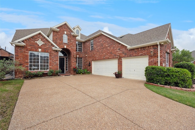 traditional home featuring brick siding, an attached garage, roof with shingles, and concrete driveway