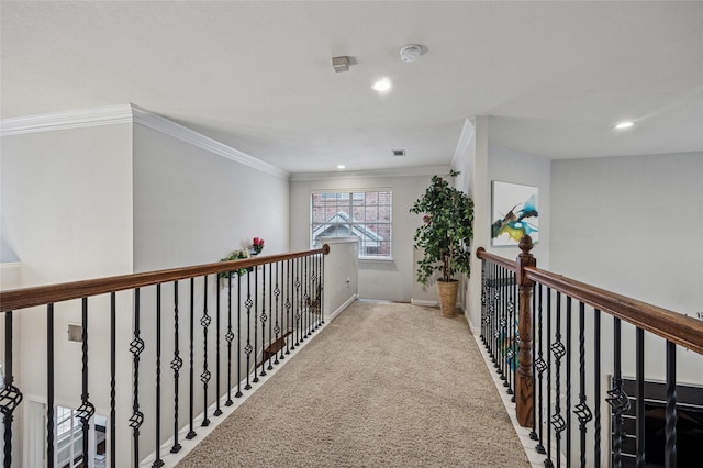 corridor with ornamental molding, baseboards, recessed lighting, carpet flooring, and an upstairs landing