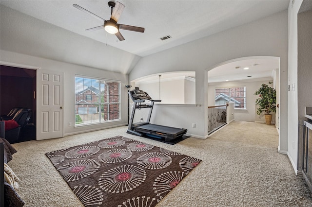 exercise area with carpet flooring, ceiling fan, visible vents, and plenty of natural light