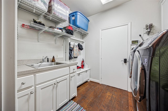 laundry room with cabinet space, separate washer and dryer, a sink, and dark wood-type flooring