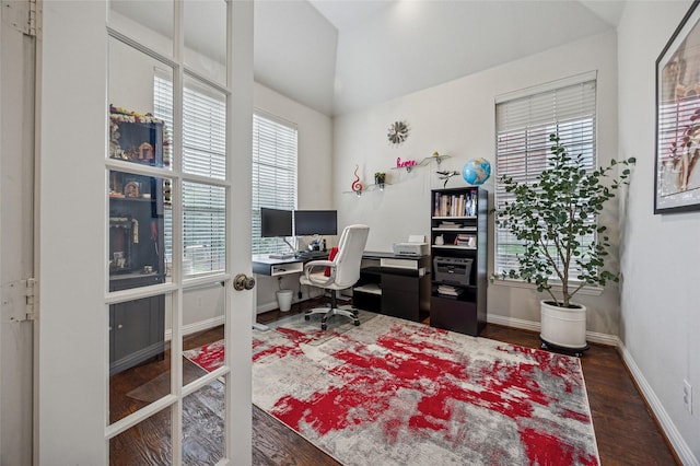 office area featuring plenty of natural light, baseboards, wood finished floors, and vaulted ceiling