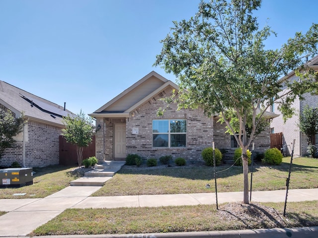 2913 Meadowlands Dr, Forney, TX 75126 - view of front of house with brick siding, fence, and a front yard