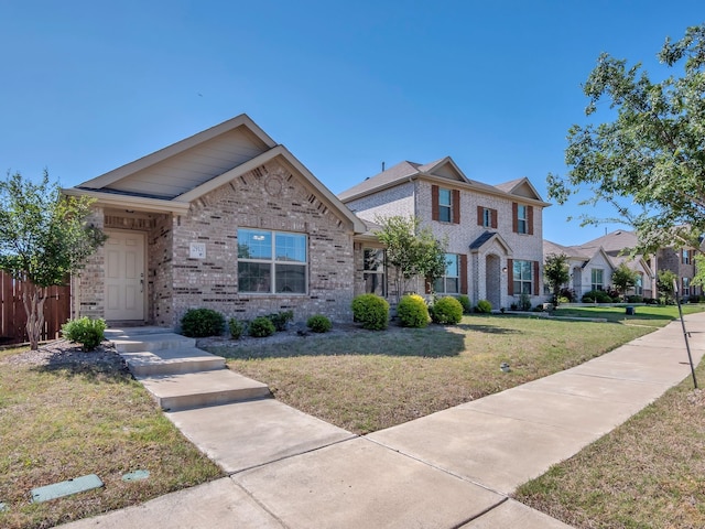2913 Meadowlands Dr, Forney, TX 75126 - view of front of home featuring fence, a front yard, and brick siding