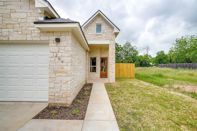 property entrance with fence and stone siding