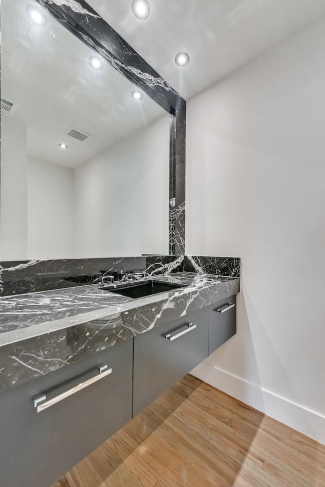7335 Royal Cir, Dallas, TX 75230 - interior details featuring visible vents, wood finished floors, baseboards, recessed lighting, and a sink