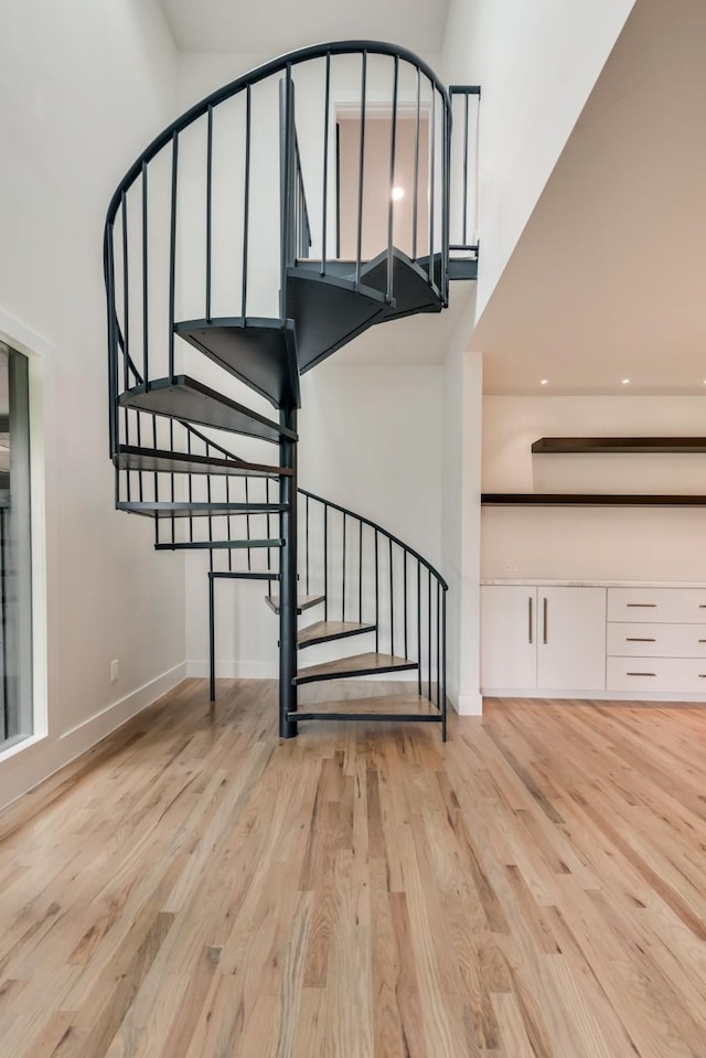 7335 Royal Cir, Dallas, TX 75230 - stairs with baseboards, a high ceiling, and wood finished floors