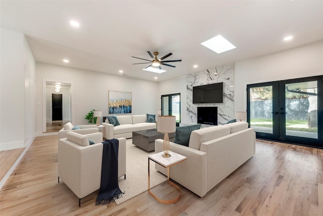 7335 Royal Cir, Dallas, TX 75230 - living room featuring light wood-style floors, baseboards, recessed lighting, french doors, and a ceiling fan