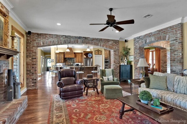 1860 Leonard Rd, Shreveport, LA 71115 - living room featuring brick wall, ornamental molding, ceiling fan, wood finished floors, and plenty of natural light