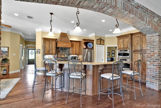 1860 Leonard Rd, Shreveport, LA 71115 - kitchen with appliances with stainless steel finishes, brown cabinets, recessed lighting, decorative backsplash, and baseboards