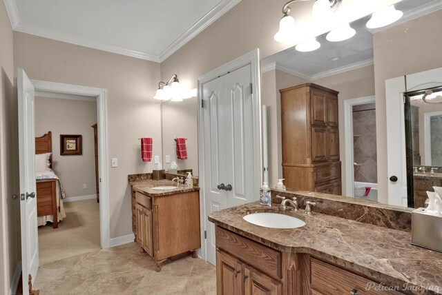 1860 Leonard Rd, Shreveport, LA 71115 - bathroom featuring two vanities, crown molding, baseboards, and connected bathroom