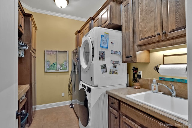 1860 Leonard Rd, Shreveport, LA 71115 - washroom with cabinet space, stacked washer / drying machine, light tile patterned floors, crown molding, and baseboards