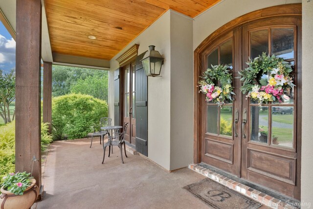 1860 Leonard Rd, Shreveport, LA 71115 - entrance to property with french doors, a porch, and stucco siding