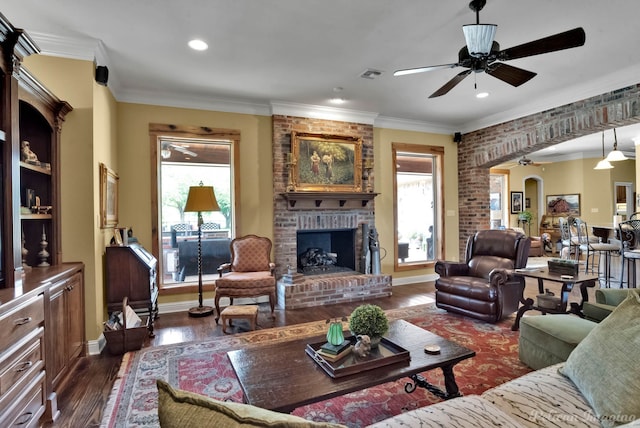 1860 Leonard Rd, Shreveport, LA 71115 - living area with ceiling fan, healthy amount of natural light, ornamental molding, dark wood-style floors, and a brick fireplace